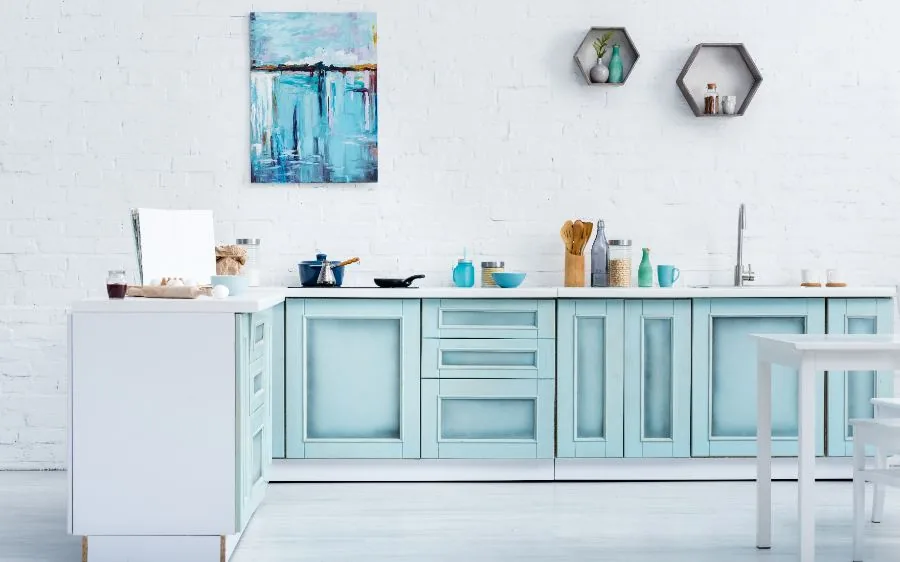 Kitchen cabinets painted a soft light blue against a white brick wall, Delray Beach, FL